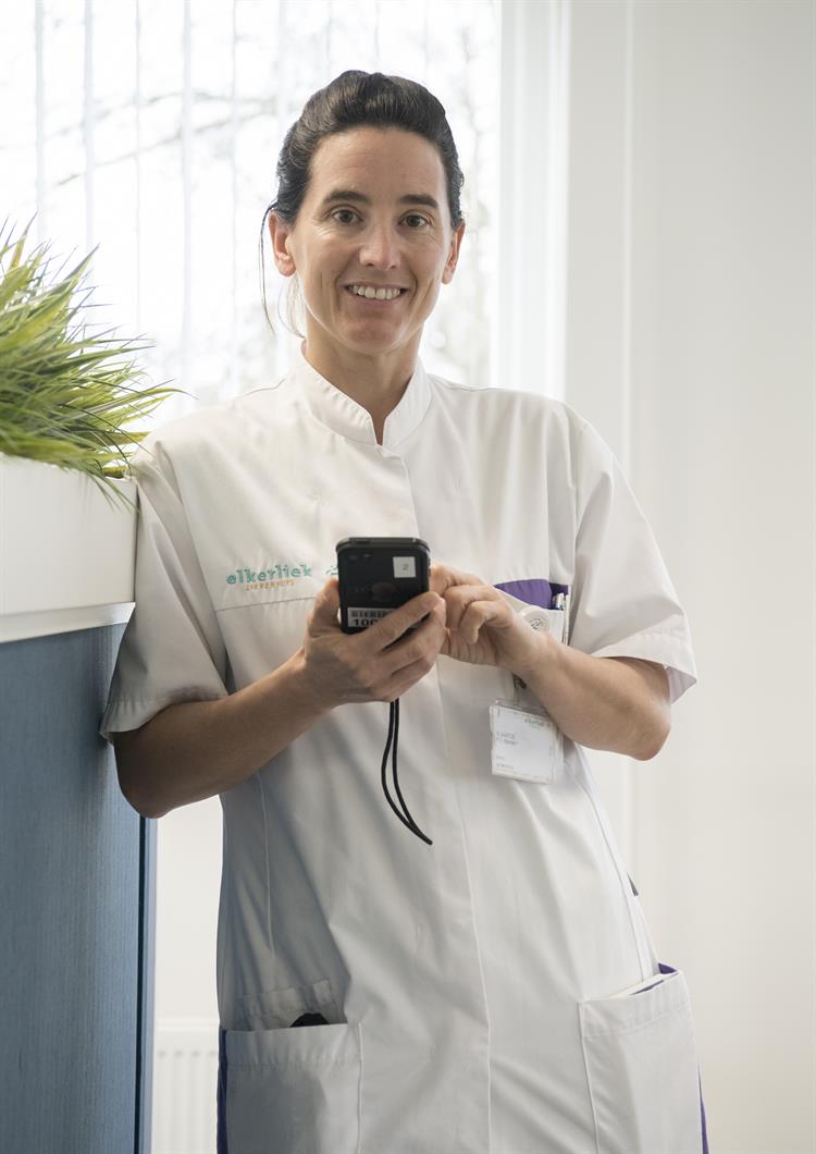 Gynaecoloog Klaartje Manders met de iPod waar de nieuwe foto-app op staat 